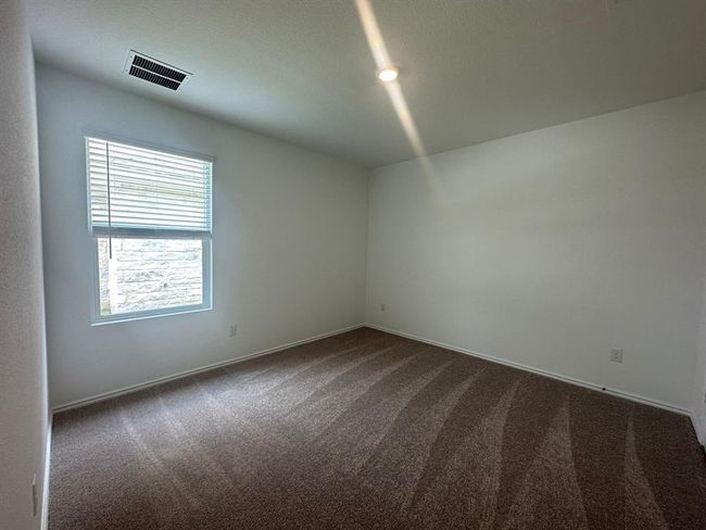 Empty room featuring dark carpet and baseboards | Image 10