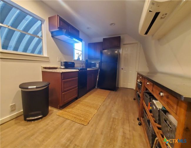 Kitchen: all electric w/updated appliances (white door is bathroom access). | Image 11