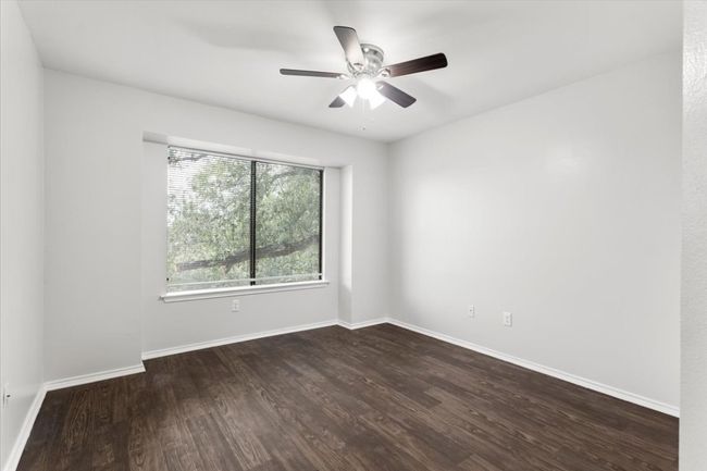 Front bedroom with large window overlooking large oak tree | Image 14