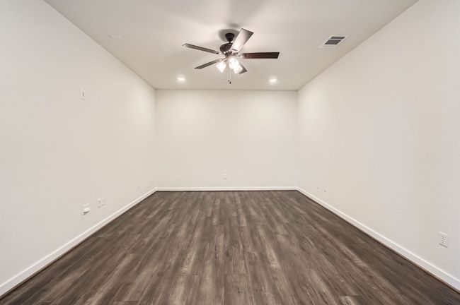 Spare room with ceiling fan, baseboards, dark wood-style flooring, and recessed lighting | Image 26