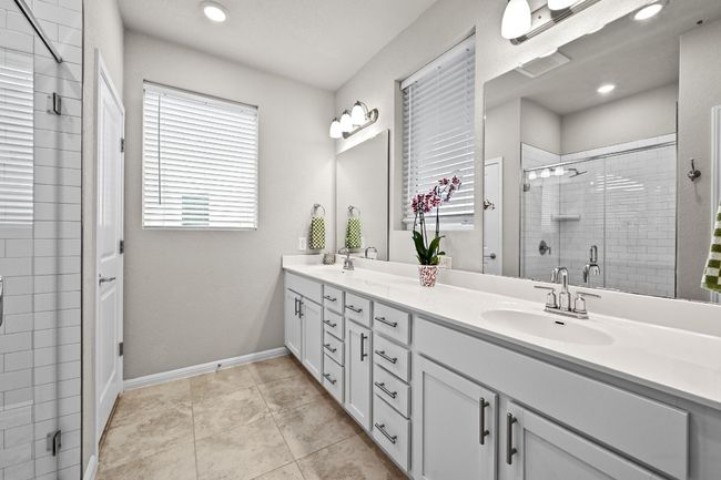 The ensuite bath is your own personal oasis, with a step-in shower and a dual vanity, giving you the perfect space to unwind after a long day | Image 19