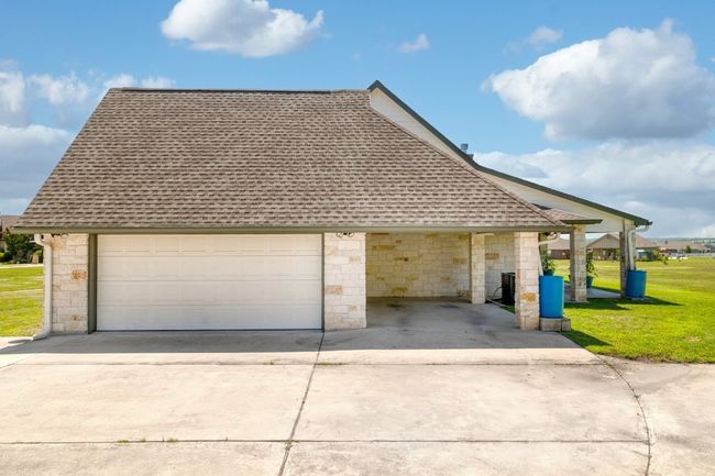 2-car garage with carport. Easy access from carport to garage to house. Garage door open installed. | Image 5
