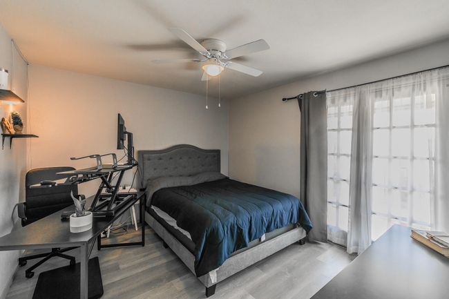 Bedroom featuring ceiling fan and wood-type flooring | Image 13