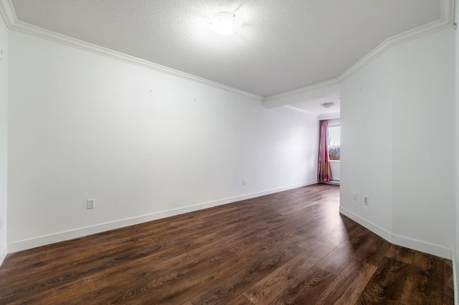 Unfurnished room featuring crown molding, dark wood finished floors, and a textured ceiling | Image 14