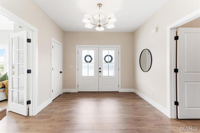 Large entry foyer with home office to your left and powder room to your right. | Image 7