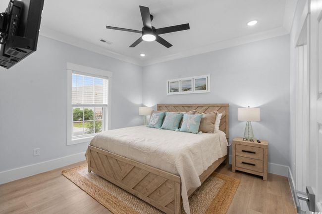 Bedroom featuring crown molding, light wood-type flooring, recessed lighting, and a ceiling fan | Image 25