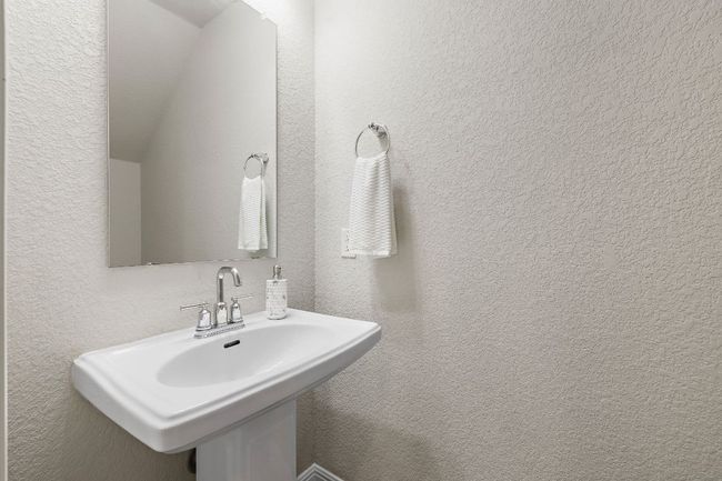 Bathroom featuring a textured wall and sink | Image 15