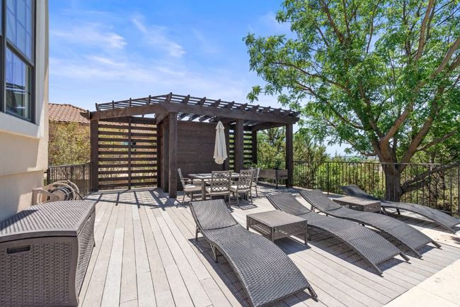 Wooden deck with outdoor dining area and a pergola | Image 27
