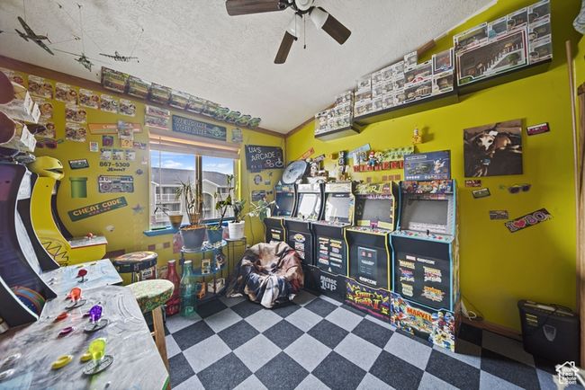 Rec room with ceiling fan, vaulted ceiling, a textured ceiling, and tile patterned floors | Image 18