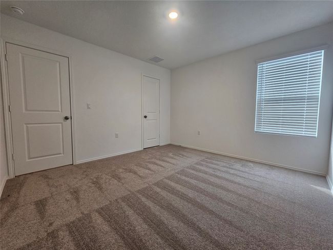 Unfurnished bedroom featuring baseboards, visible vents, and carpet floors | Image 22