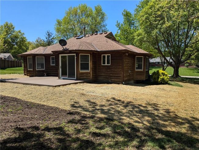 Back of property featuring a shingled roof, a patio, and fence | Image 10