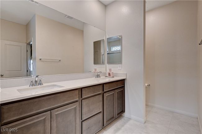 Bathroom featuring double vanity and baseboards | Image 24
