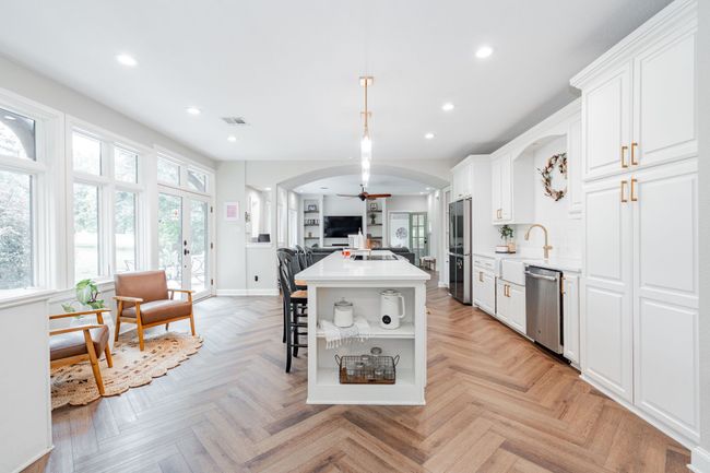 Kitchen featuring stainless steel appliances, ceiling fan and arched walkways | Image 5