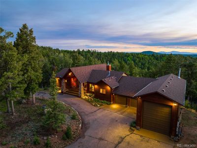 The front of the home with circular drive and lighted island landscaping | Image 1