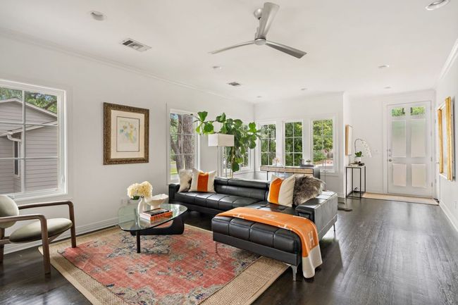 Living area featuring baseboards, crown molding, a ceiling fan, and wood finished floors | Image 38