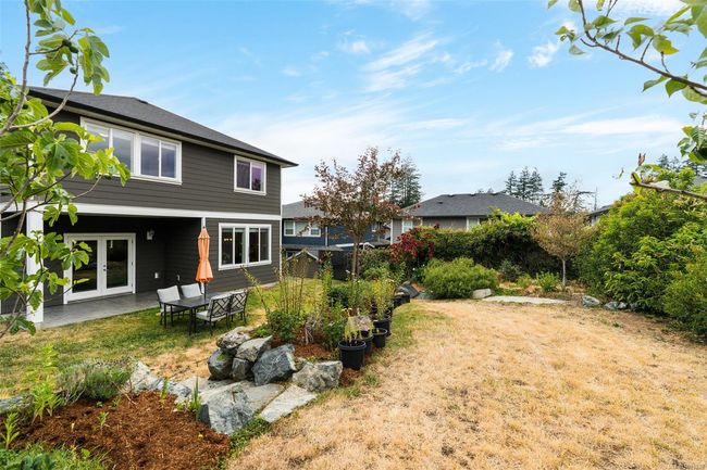 Rear view of house featuring french doors, a lawn, and a patio area | Image 27