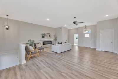 Living room with light wood-type flooring and ceiling fan | Image 3