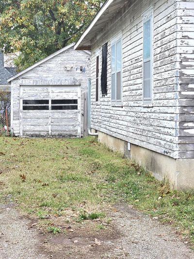 View of side of home with a garage | Image 2