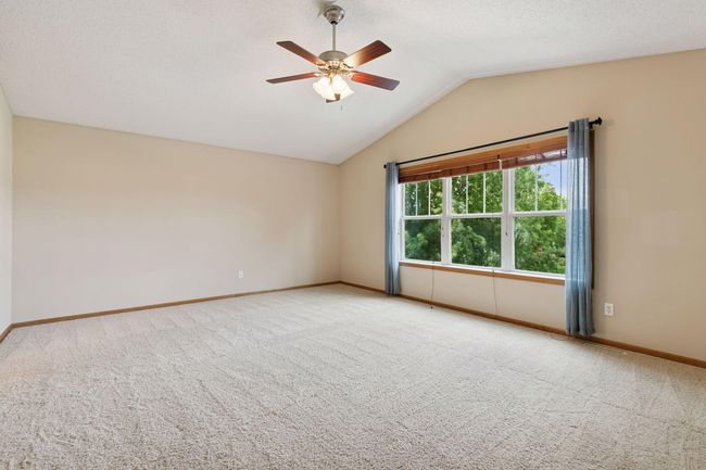 The enormous primary bedroom measures 19x15 and has a vaulted ceiling | Image 12