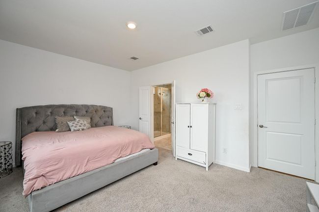 Generously sized primary bedroom offers ample space for a California king and a full sitting area. | Image 4