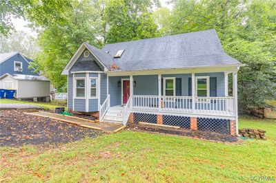 View of front of property with a porch, a storage unit, and a front yard | Image 3