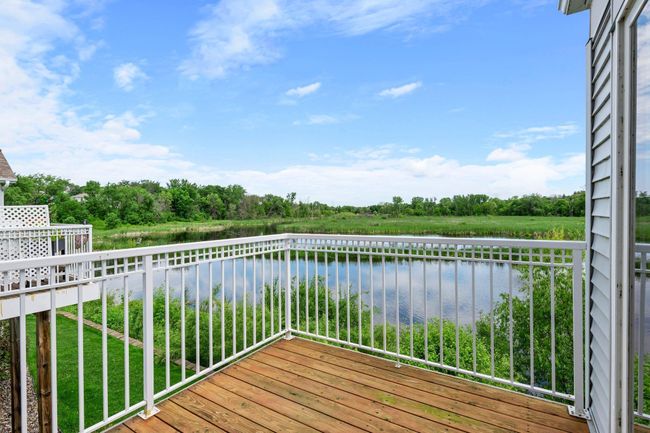 Deck view of the pond, water fountain and grasslands. | Image 12