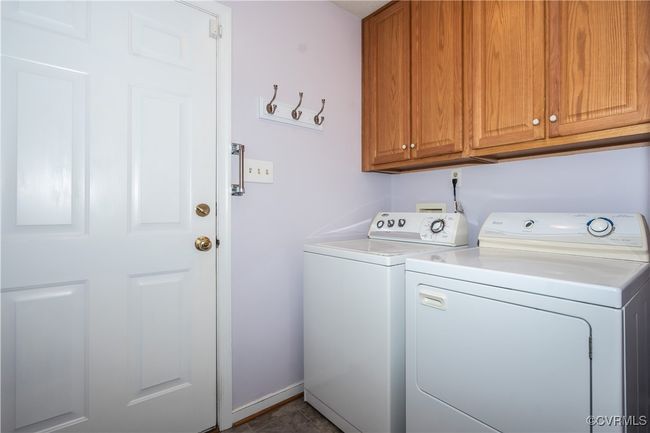 Washroom with washing machine and clothes dryer, cabinet space, and tile patterned floors | Image 10