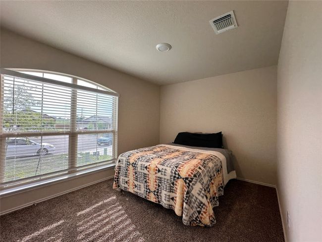 Bedroom with dark carpet and baseboards | Image 6