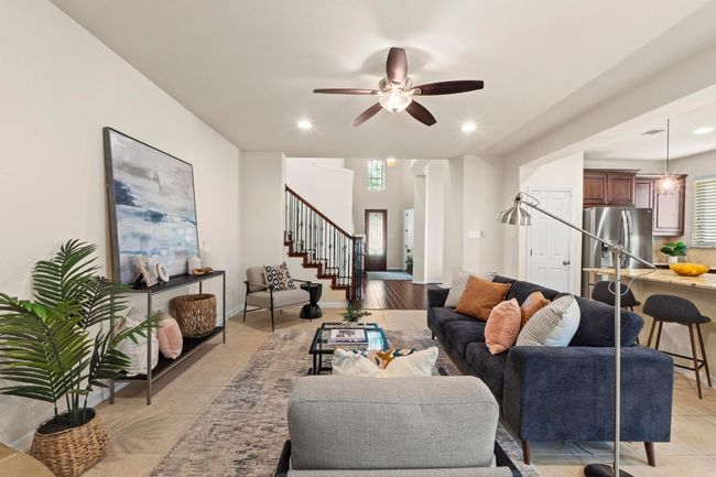 Living area with stairs, ceiling fan, recessed lighting, and light tile patterned floors | Image 7