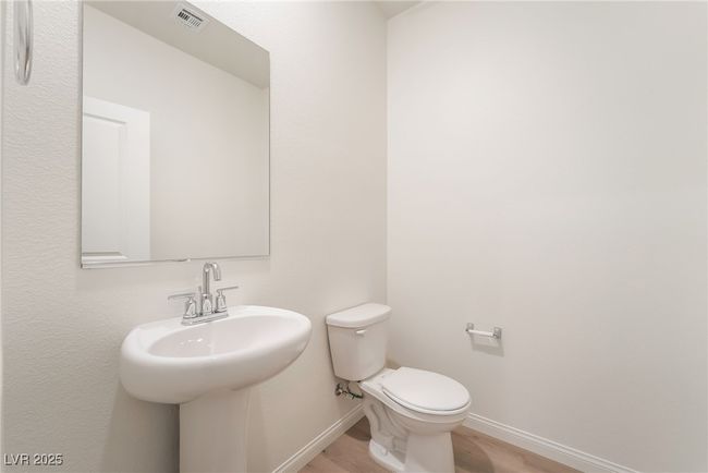 Half bathroom featuring baseboards and wood finished floors | Image 16