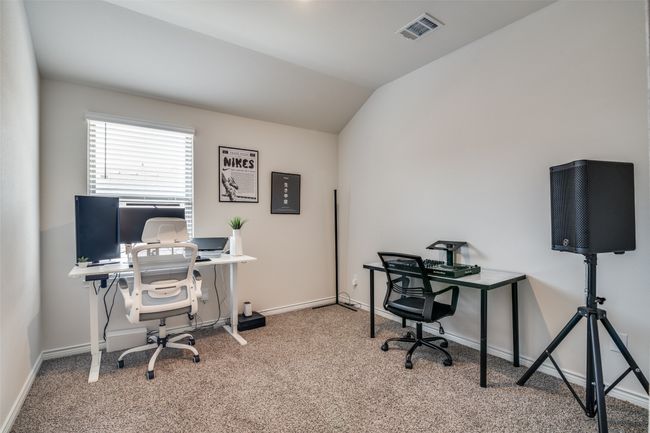 Carpeted office space with baseboards and lofted ceiling | Image 22
