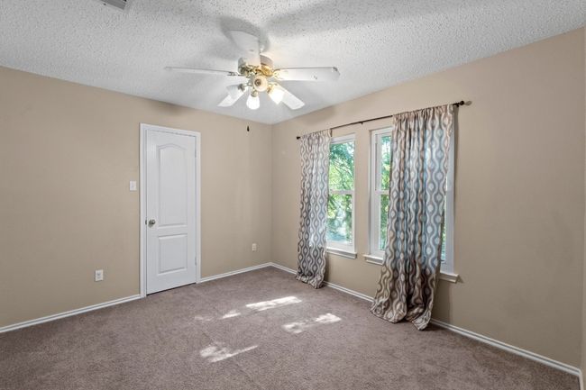 Spare room featuring carpet, ceiling fan, a textured ceiling, and​​‌​​​​‌​​‌‌​‌‌​​​‌‌​​‌‌​‌​​​​​‌ baseboards | Image 25