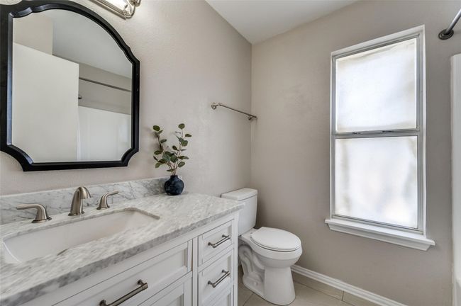 Secondary Full Bathroom with baseboards, toilet, tile patterned flooring, and vanity | Image 18