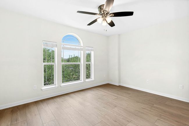 Empty room with wood finished floors and ceiling fan | Image 17