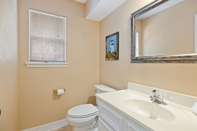 This downstairs power room is just off the kitchen, offering your guests convenience and privacy. | Image 21