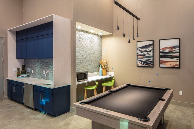 Recreation room with a towering ceiling, billiards, and sink | Image 11
