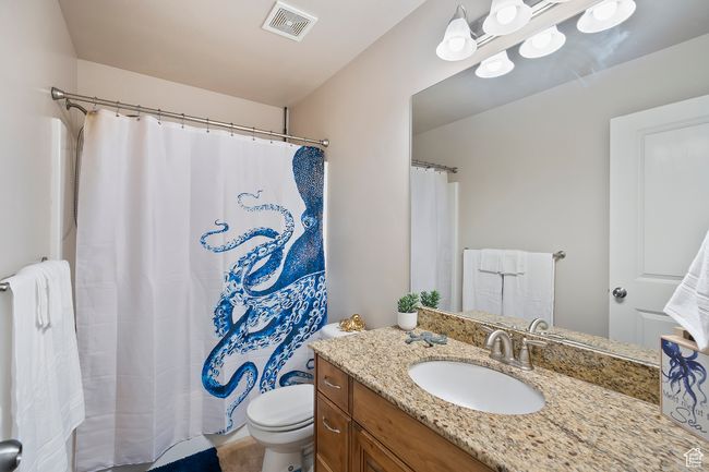 Full bathroom with vanity, radiator, and curtained shower | Image 21