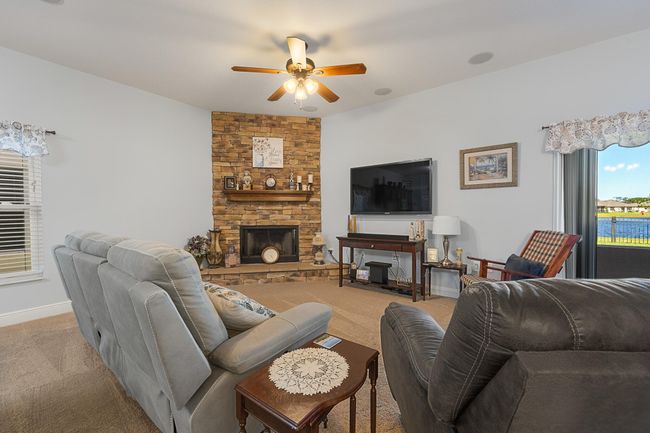 Wood burning stacked stone fireplace in living room | Image 6