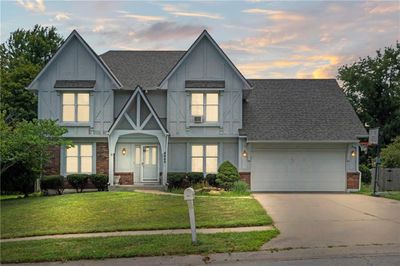 View of front of home featuring a garage and a yard | Image 2