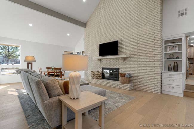 Formal living room with floor-to-ceiling brick fireplace | Image 26