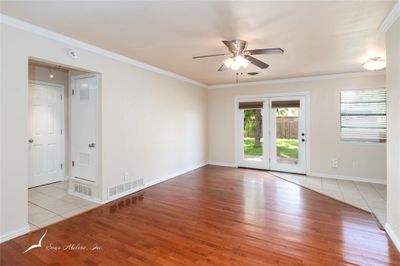 Empty room with ceiling fan, light hardwood / wood-style floors, and ornamental molding | Image 3