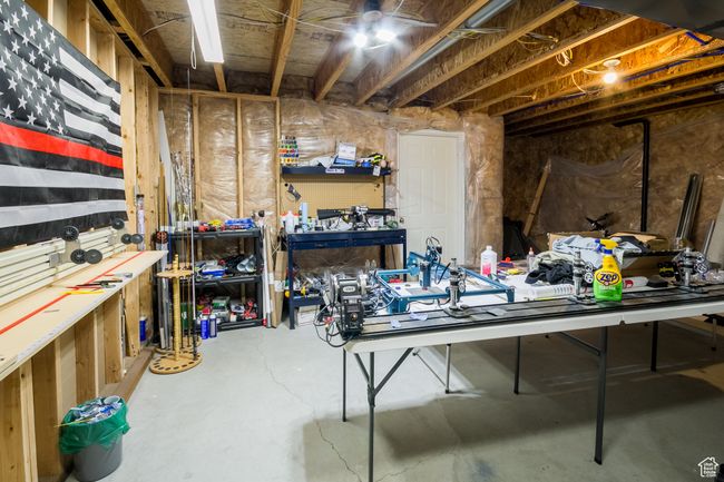 Unfinished below grade area featuring a workshop area | Image 22