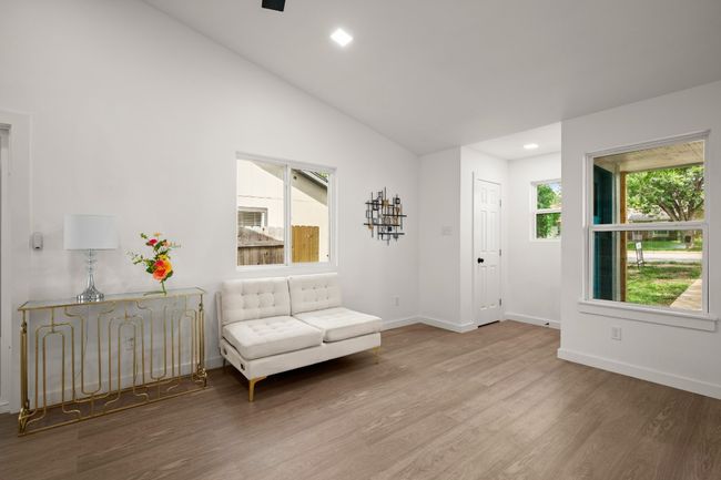 Living area with wood finished floors, lofted ceiling, and recessed lighting | Image 7
