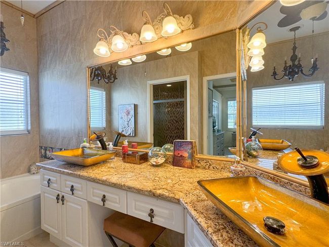 Bathroom featuring dual vanity and a washtub | Image 48