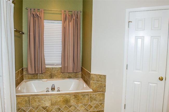 Bathroom featuring a garden tub | Image 12
