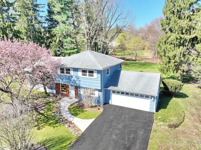 View of front of home with a garage, a front lawn, and aphalt driveway | Image 38