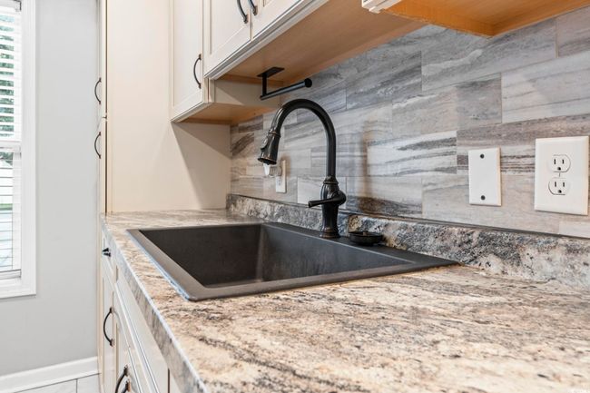 Kitchen view of backsplash and white cabinetry | Image 8