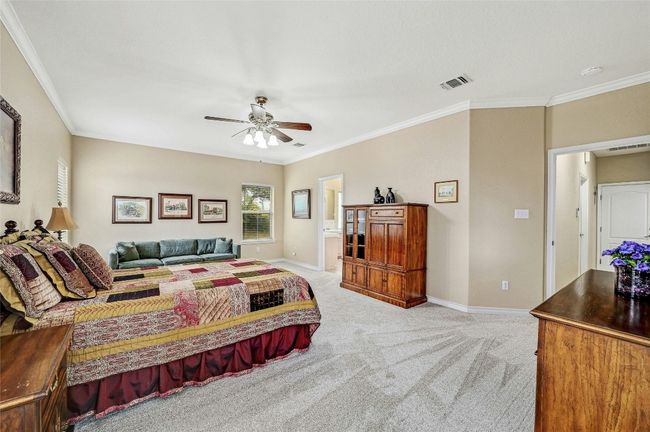 With a split floor plan, you can enjoy your privacy in this spacious primary bedroom. | Image 14