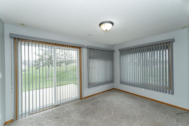 Nice sunroom walks out to the patio area behind. | Image 8