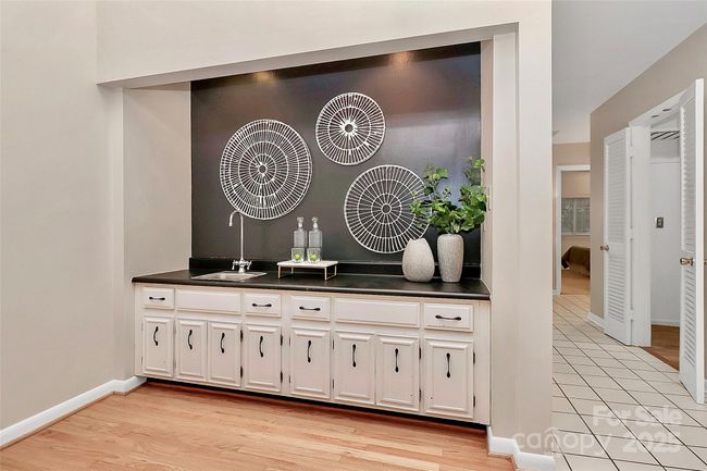 The sleek wet bar offers plenty of functional storage & additional entertaining space. | Image 7